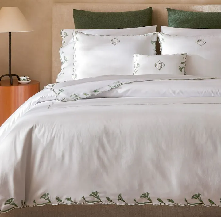 A bed featuring Marcella bed linens