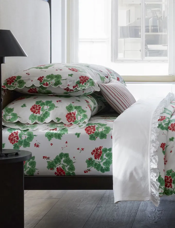 A view of a bed of Geranium bed linens