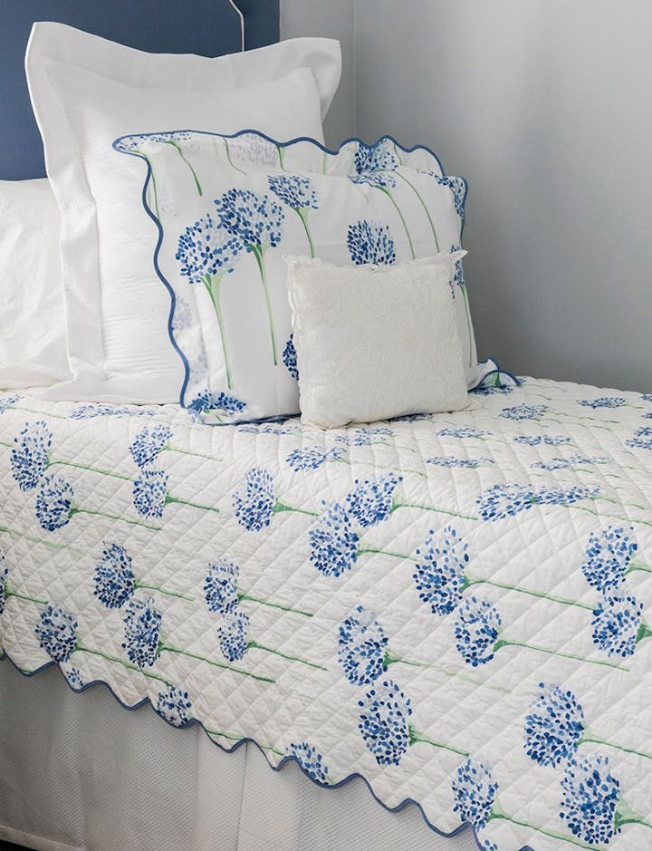 A closeup view of a bed featuring Charlotte, a Matouk print by Lulu DK.