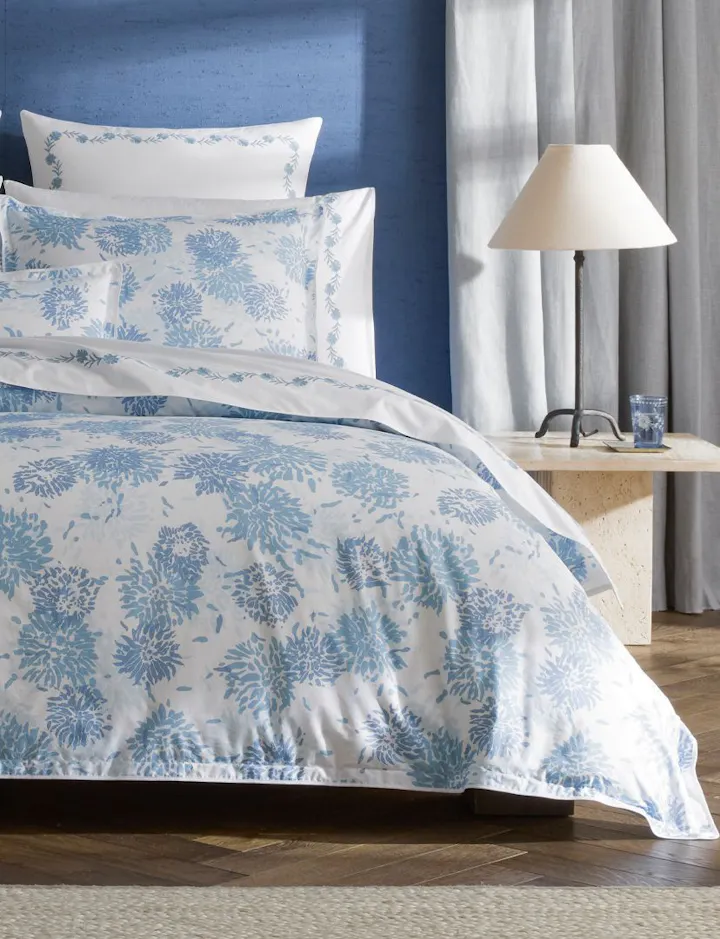 A view of a bed featuring Chrysanthemum bed linens