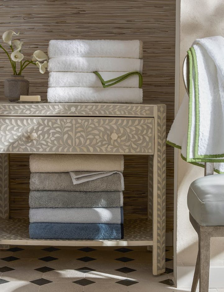 A stack of Enzo towels in various colors