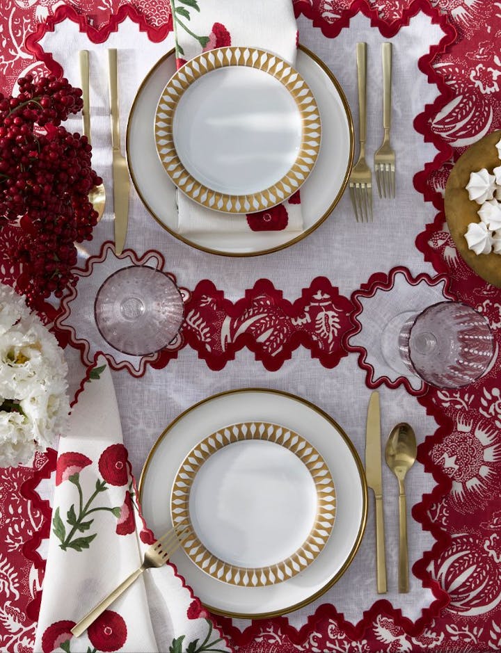 An overhead view of a table with a Granada tablecloth in Scarlet.