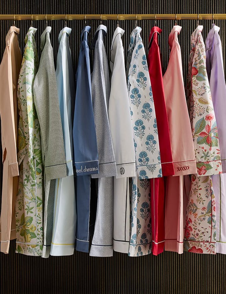 A selection of pajama styles hanging on a rack.