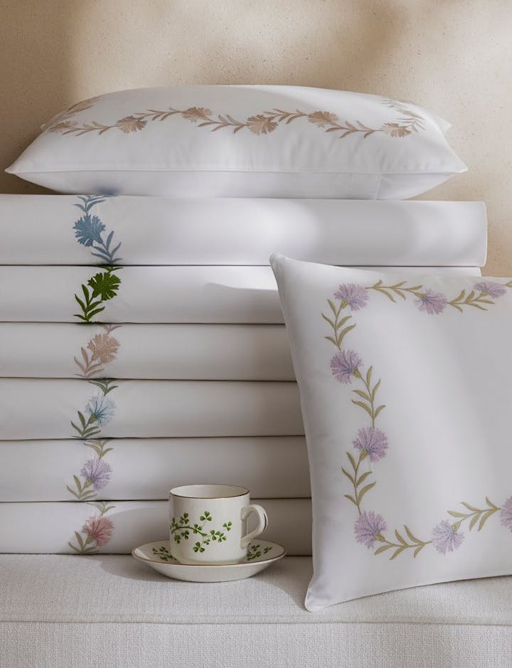 A view of a stack of Daphne bed linens