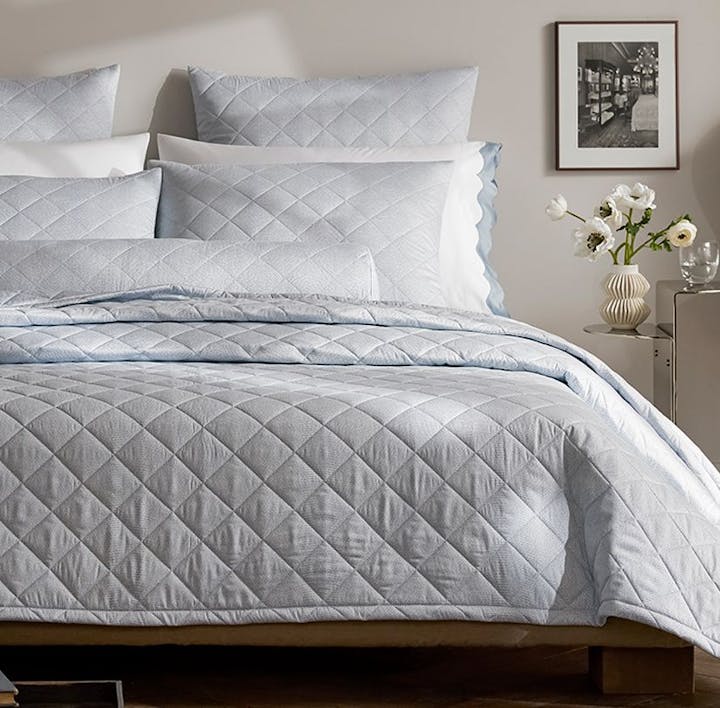 A bed featuring the Jasper Quilt and other Jasper bed linens.