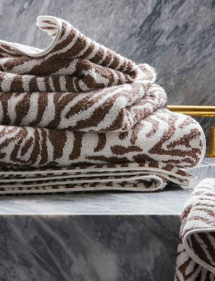 A stack of Regine towels in the Sable color.