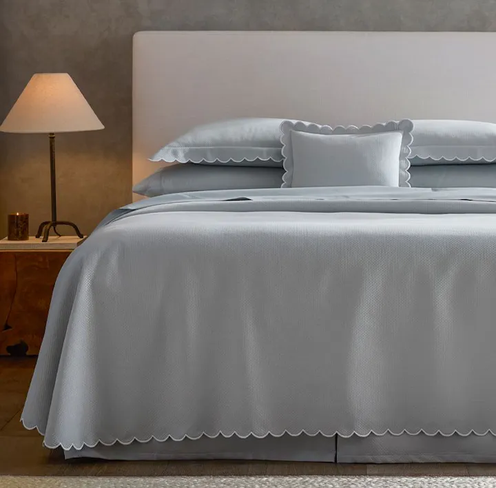 A bed featuring Diamond Pique bed linens