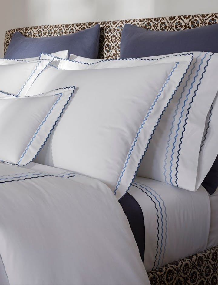 A view of a bed featuring Axel linens