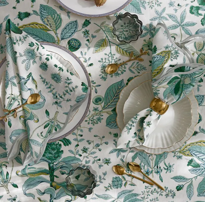 A closeup of a place setting featuring Pomegranate linens