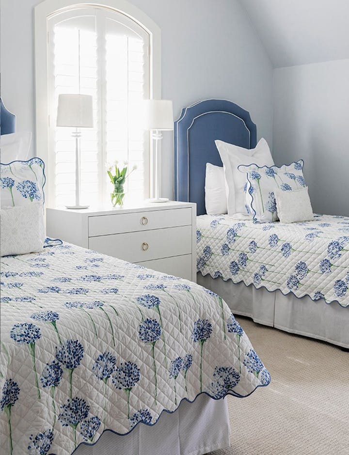 A bed featuring Charlotte, a Matouk print by Lulu DK.