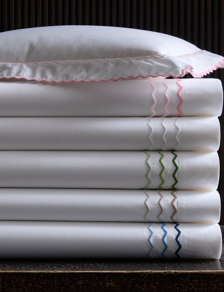 A stack of Axel bed linens, showing various colors