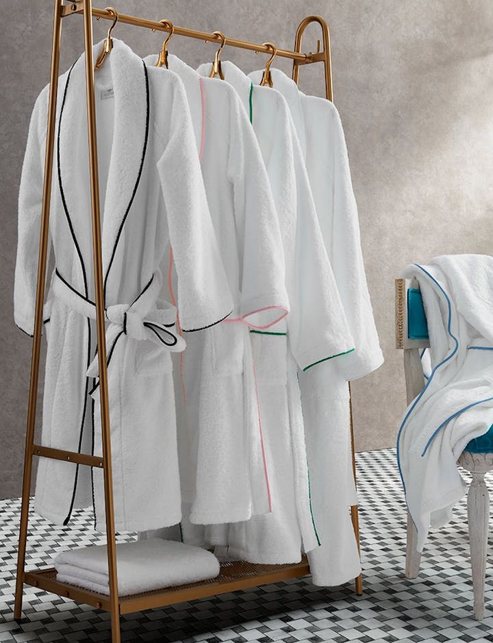 A view of several Cairo robes hanging on a clothing rack.