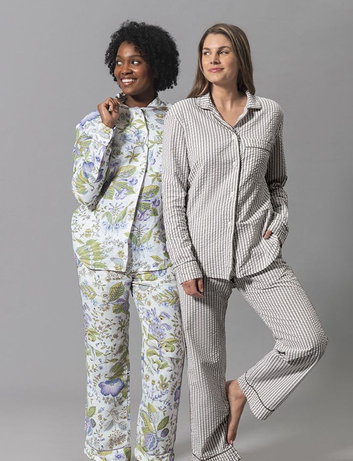 A view of two models wearing Matouk pajamas