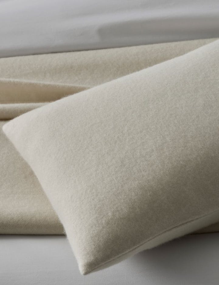 A detail of a Venus pillowcase, with a Venus blanket below