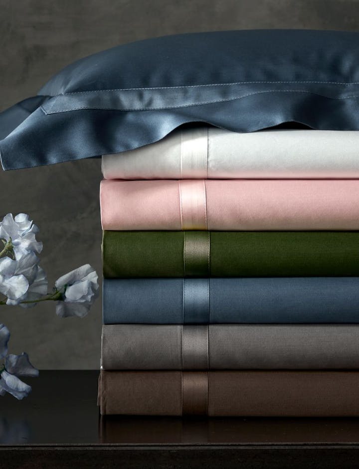 A stack of Nocturne bed linens.