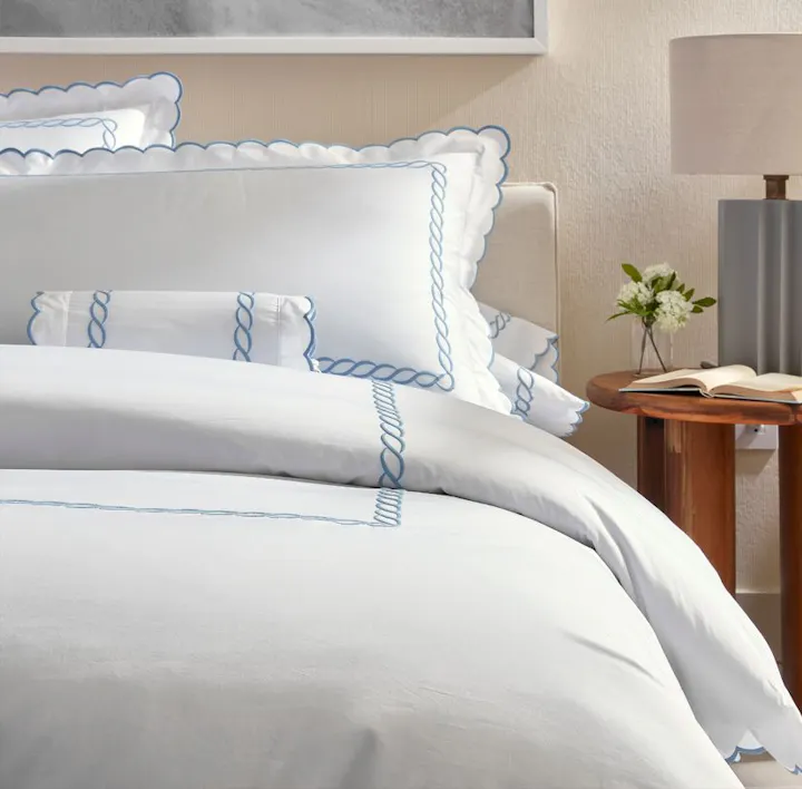 A bed featuring Classic Chain Scallop bed linens