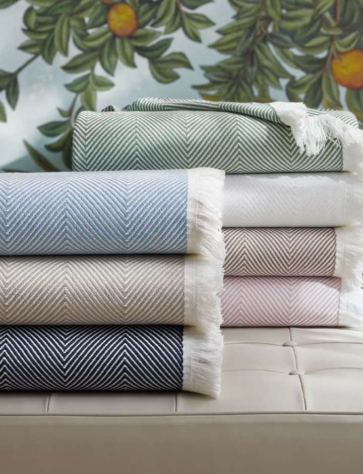 A view of stacked Leo Throws