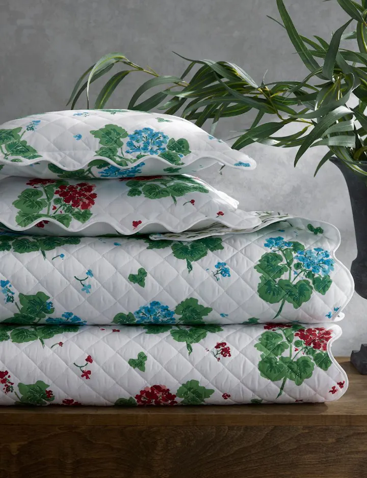 A stack of Geranium quilt bed linens