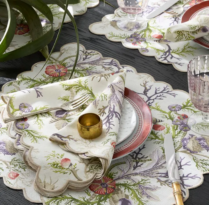 A closeup of a place setting featuring Del Tesoro linens