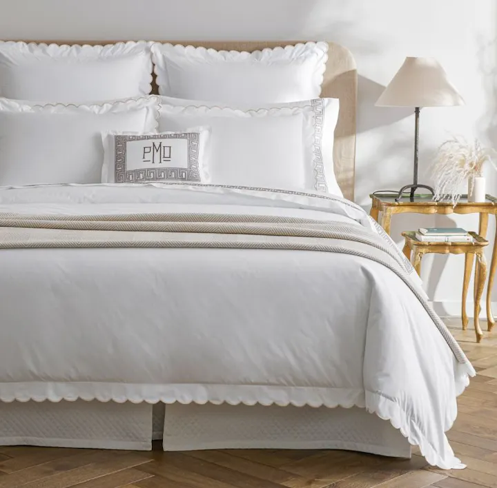 A bed featuring Dakota bed linens